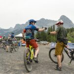 rockies 24 mountain bike racers fist bump cheer
