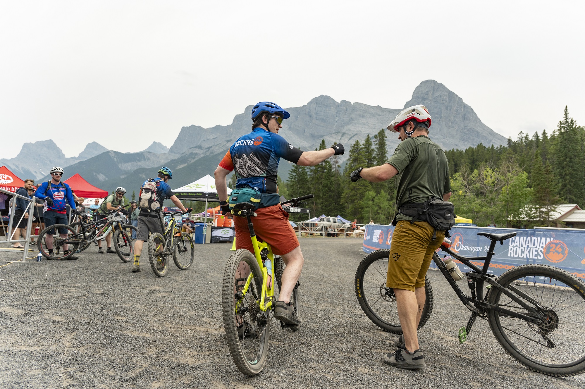 rockies 24 mountain bike racers fist bump cheer